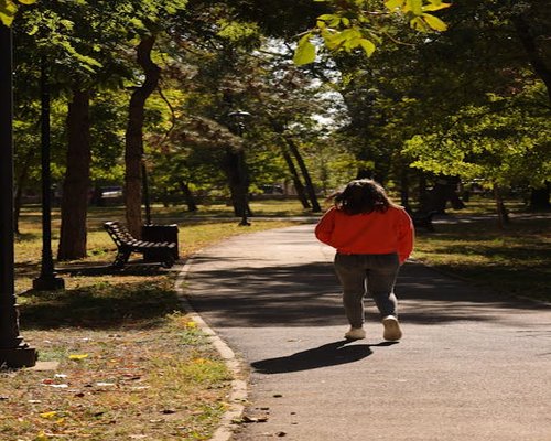 Woman taking a relaxing walk in a sunny park